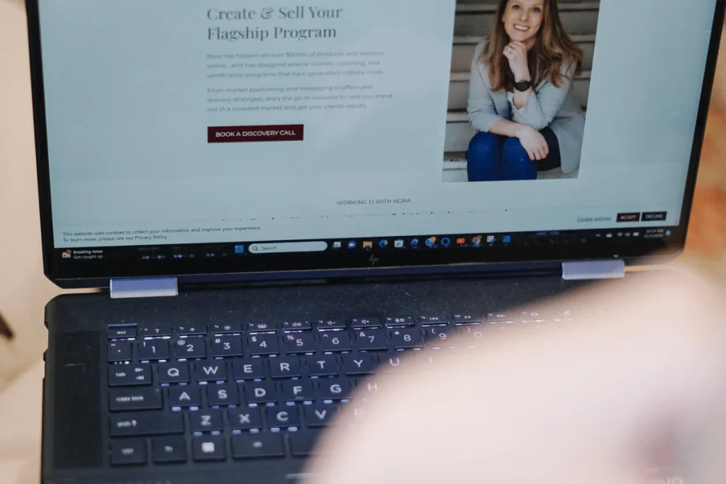 A person is using their laptop to create a website.