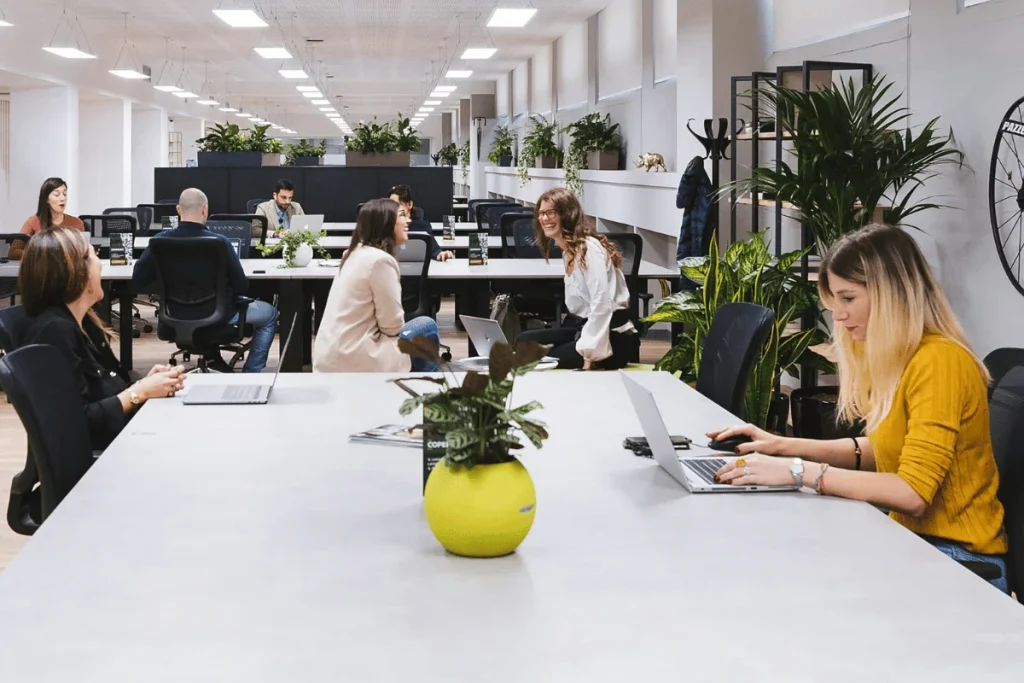 Modern coworking office with employees working on laptops.