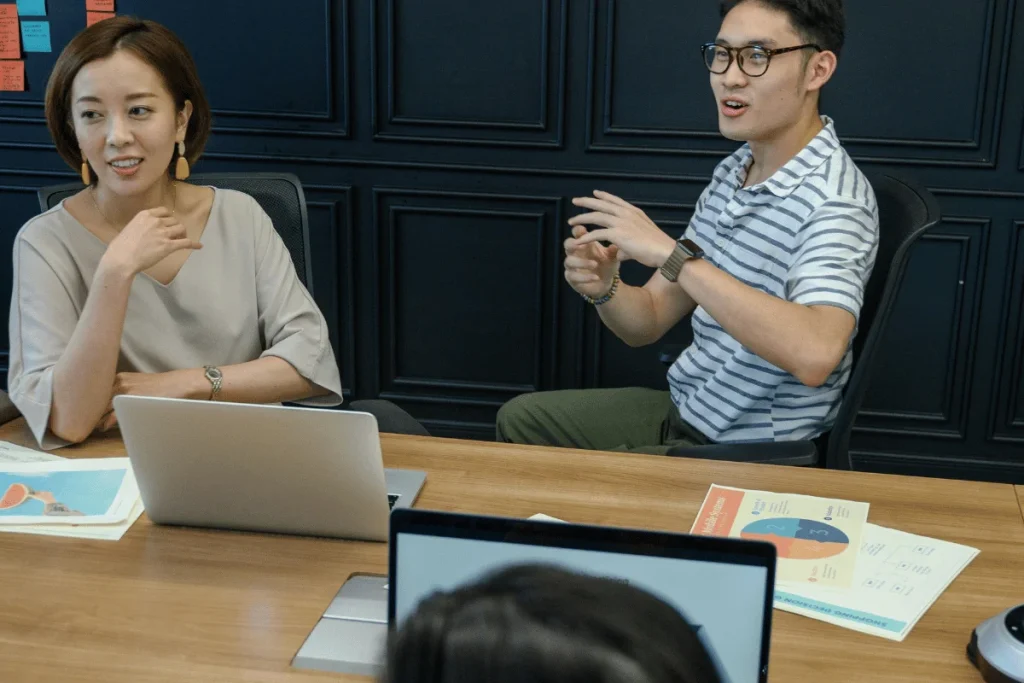 Team members discussing strategy during office meeting.