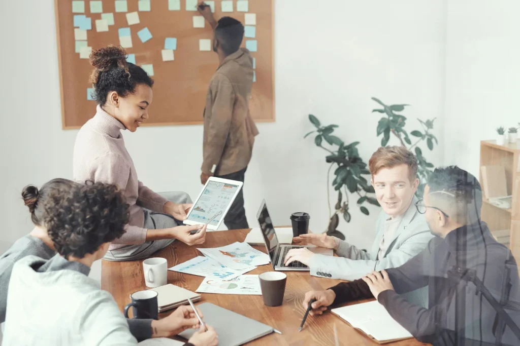 Diverse team working together with charts and data during a meeting.