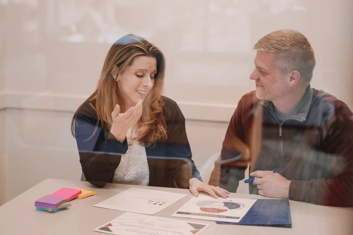 Businesswoman conversing with colleague during a collaborative work session.