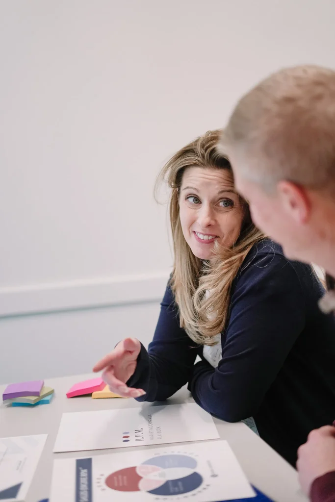Business consultant discussing strategy with a client at a meeting.
