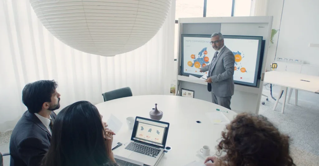 Man presents at a conference with colleagues, highlighting business strategy discussion and collaborative decision-making.