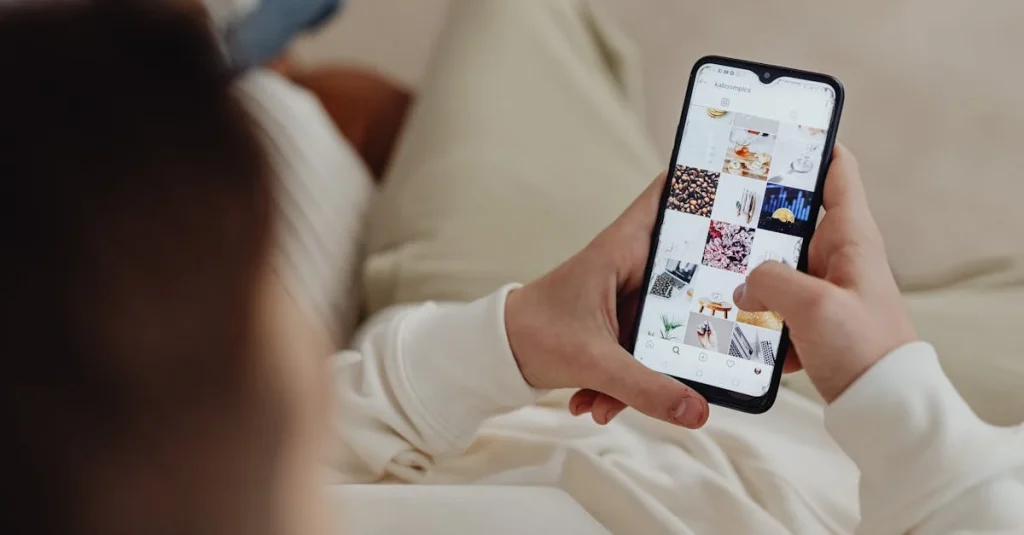 Person holding smartphone displaying social media feed with multiple content posts for b2b content marketing strategy.