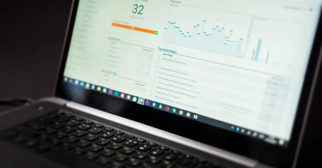 Laptop displaying analytics dashboard with performance metrics, score of 32, and content marketing data visualization charts.